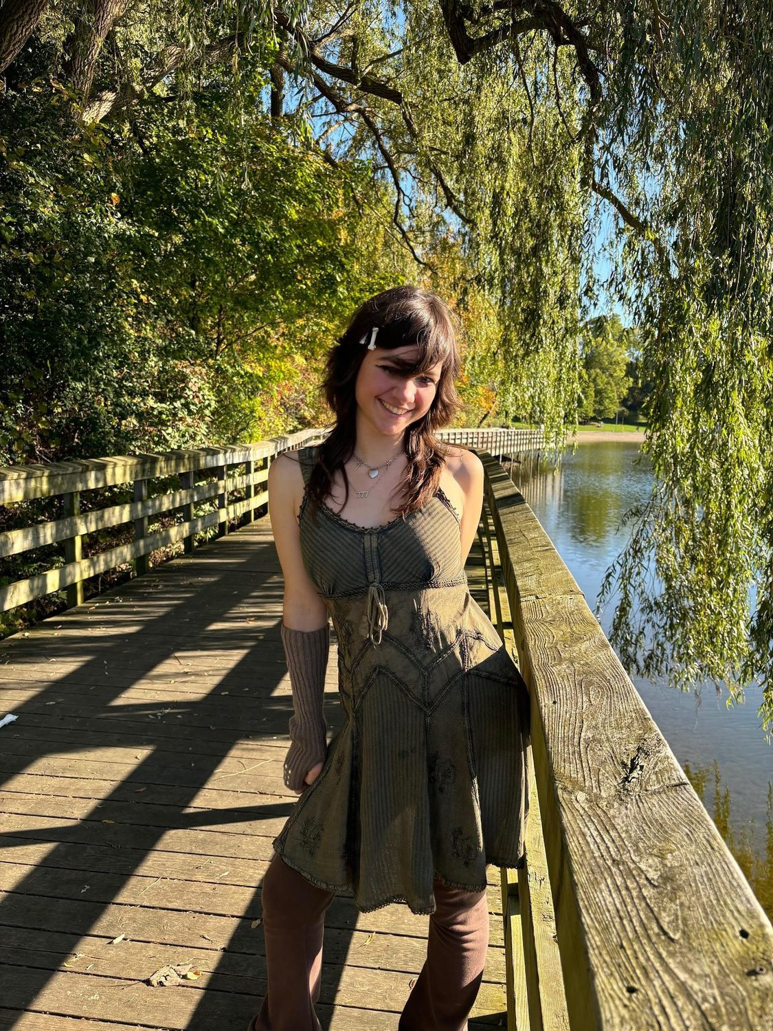 Megan beneath a willow tree by the water