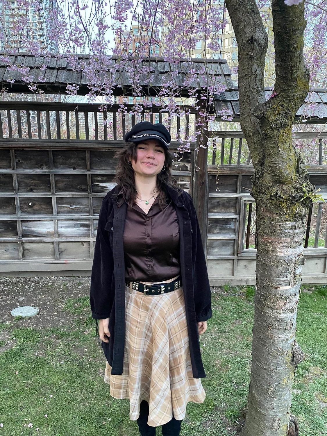 Megan Ellul outdoors on a willow-lined bridge