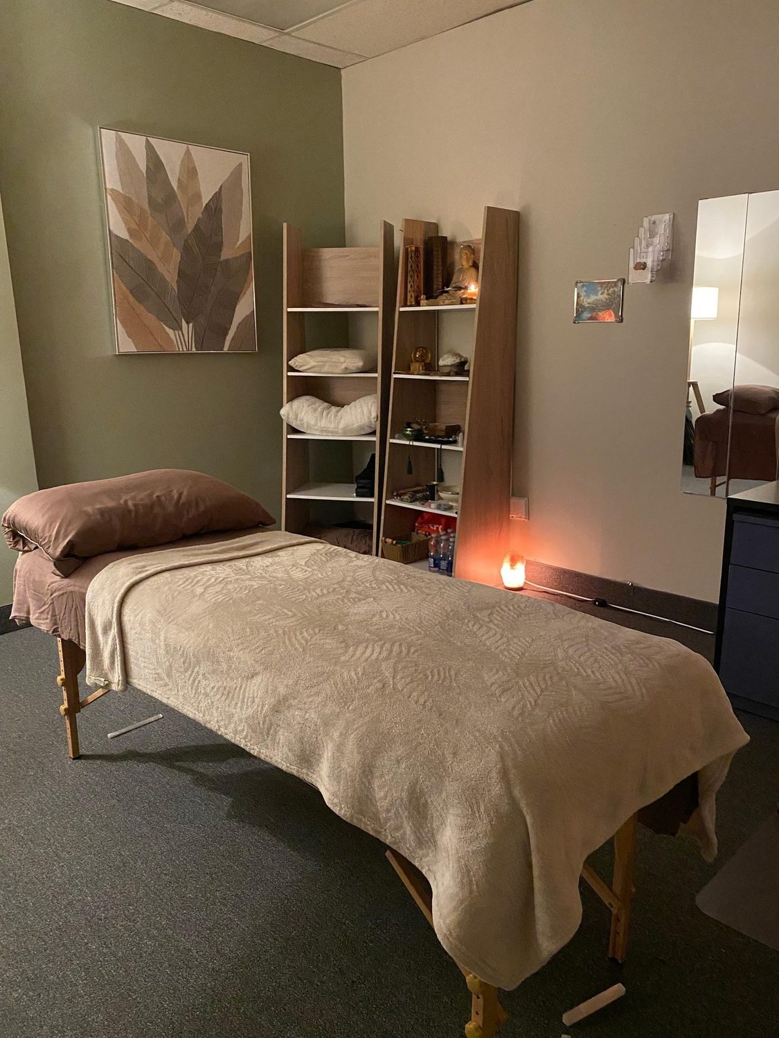 The treatment room with massage table and soft lighting